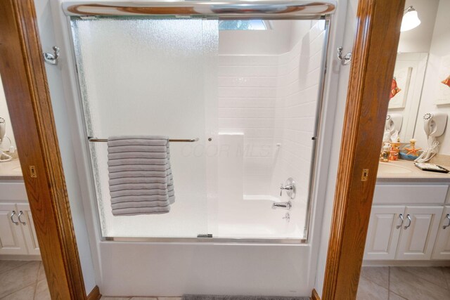 full bath with tile patterned floors, vanity, and combined bath / shower with glass door