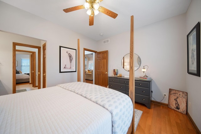 bedroom with visible vents, baseboards, light wood-style floors, and a ceiling fan