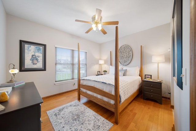 bedroom featuring light wood-style flooring, baseboards, and ceiling fan