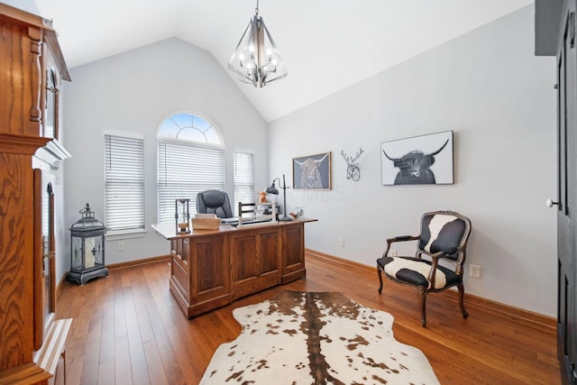 office area with hardwood / wood-style floors, high vaulted ceiling, baseboards, and a chandelier