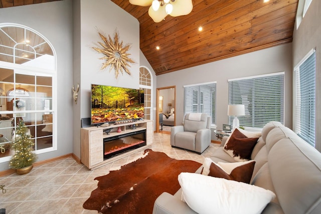 living area featuring light tile patterned floors, baseboards, high vaulted ceiling, and wooden ceiling