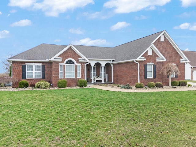view of front facade featuring brick siding and a front lawn