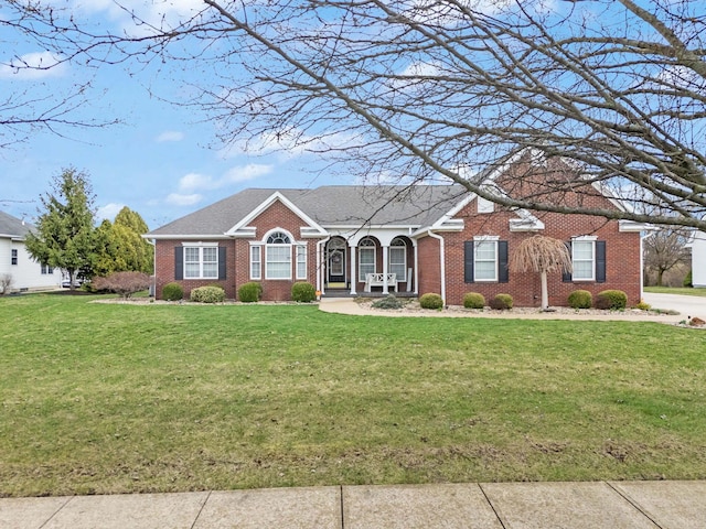 single story home with brick siding, roof with shingles, and a front yard