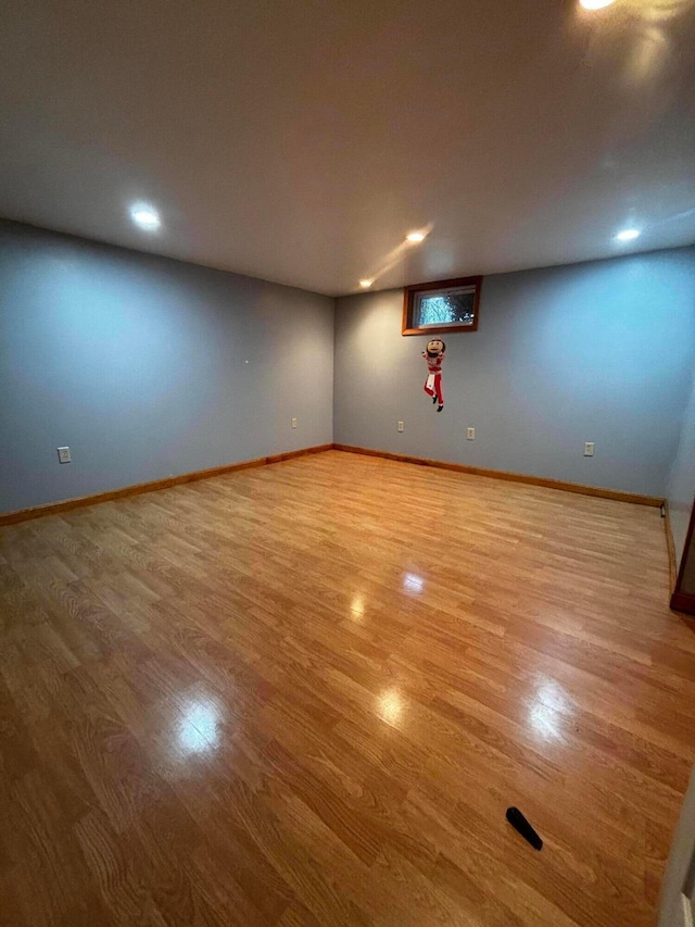 empty room with baseboards and wood finished floors