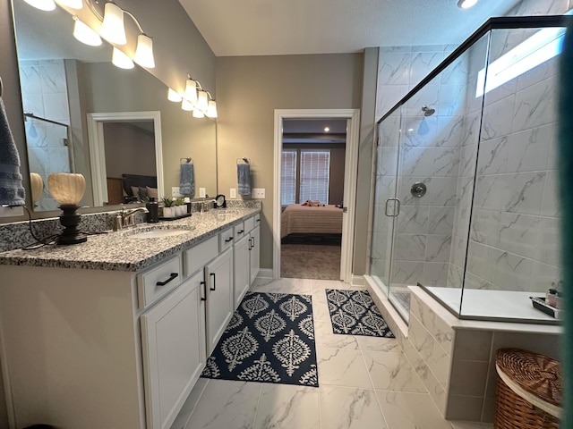 full bath with double vanity, a stall shower, a sink, ensuite bathroom, and marble finish floor