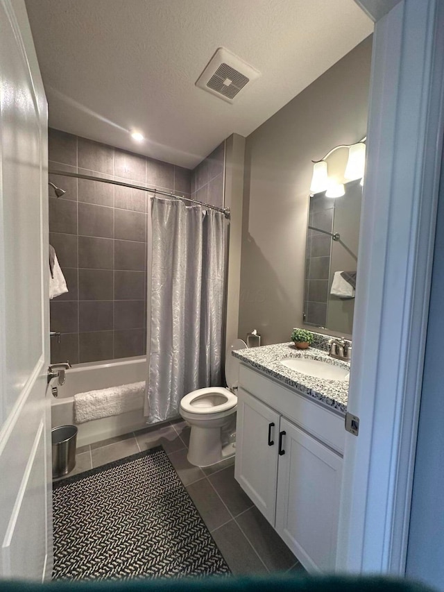 bathroom with visible vents, toilet, tile patterned floors, shower / bath combination with curtain, and vanity