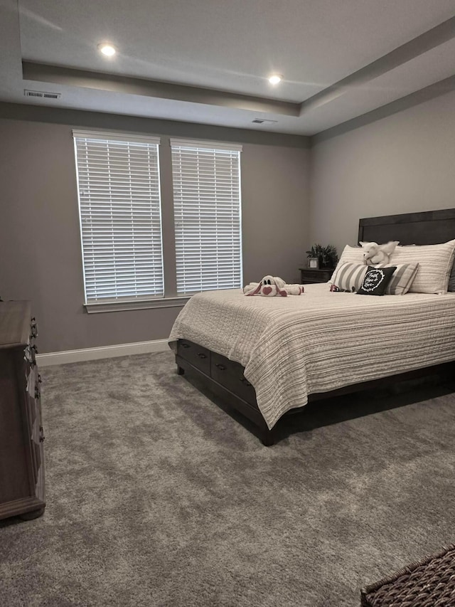 bedroom with visible vents, baseboards, recessed lighting, a raised ceiling, and carpet flooring