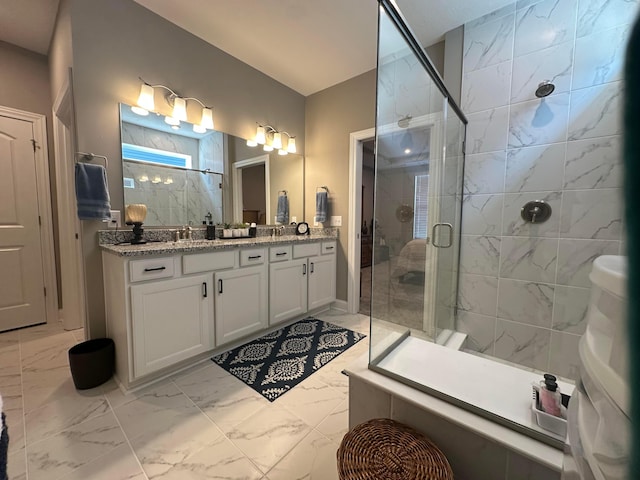 full bathroom with vanity, a shower stall, and marble finish floor