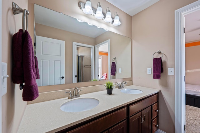 ensuite bathroom featuring ensuite bath, double vanity, and a sink