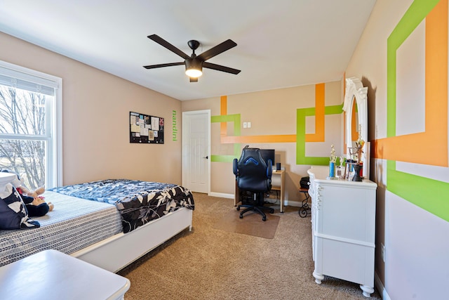 bedroom with a ceiling fan, carpet, and baseboards