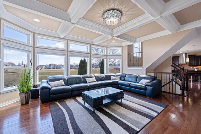 living area with beam ceiling, dark wood-type flooring, a chandelier, and coffered ceiling