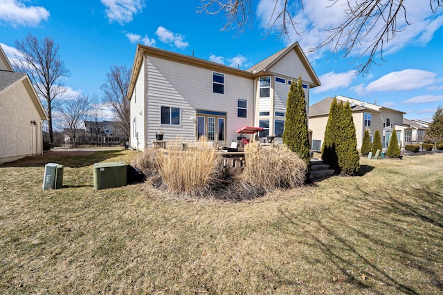 rear view of property with a lawn