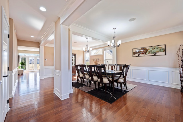 dining area featuring dark wood-style floors, french doors, and an inviting chandelier