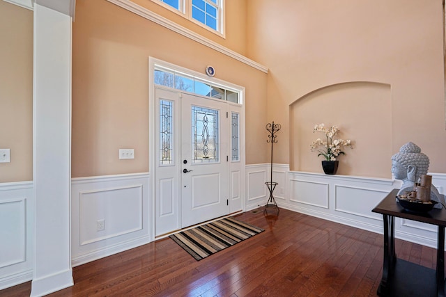 entryway with dark wood-type flooring and a wainscoted wall