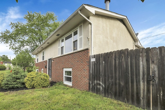view of side of home with brick siding and stucco siding