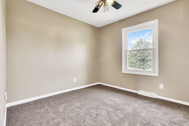 spare room with carpet, baseboards, and a ceiling fan