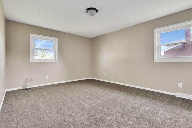 carpeted empty room with baseboards