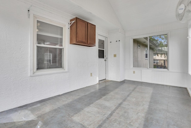 interior space featuring lofted ceiling and concrete floors