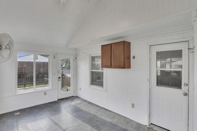 unfurnished sunroom featuring vaulted ceiling