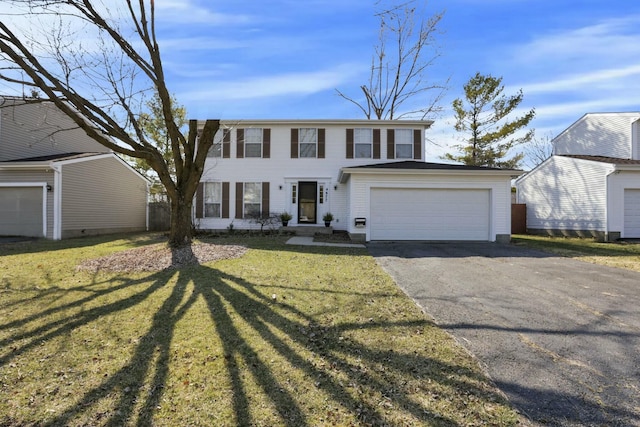 view of front of property featuring aphalt driveway, a garage, and a front yard