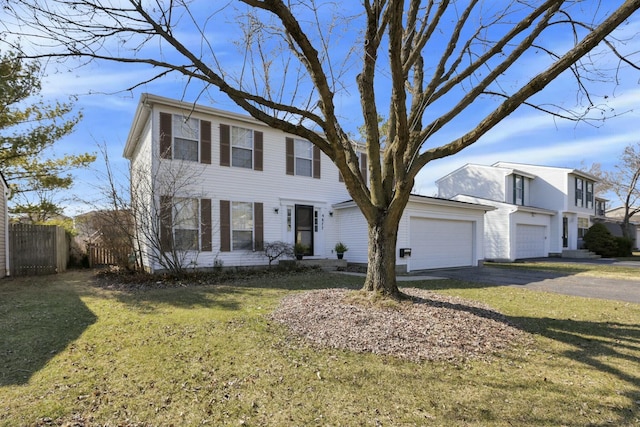 view of front of house with driveway, an attached garage, a front yard, and fence