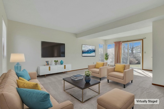 living area with light carpet and baseboards