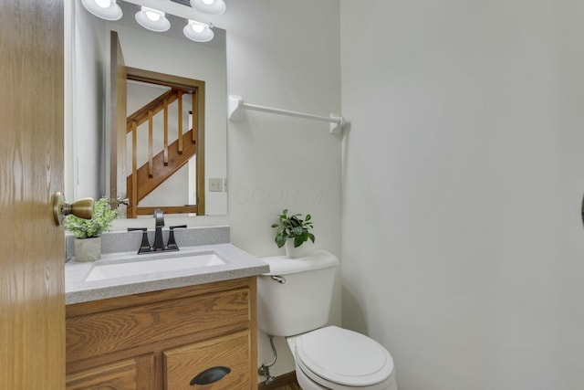 bathroom featuring toilet and vanity