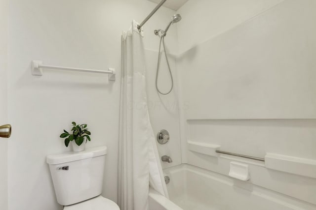 bathroom featuring shower / bath combination with curtain and toilet