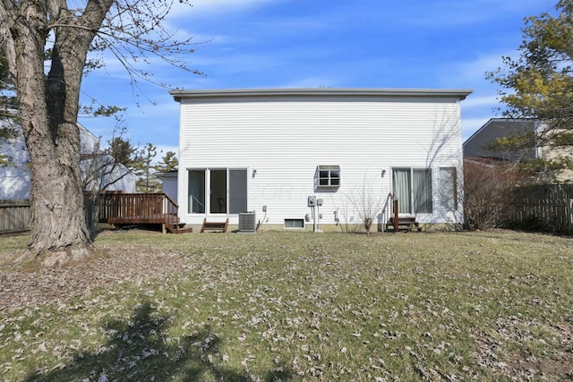 back of property with cooling unit, a yard, a deck, and fence