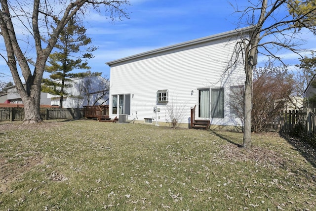 back of property featuring entry steps, central air condition unit, a yard, and a fenced backyard