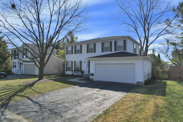 view of front of house featuring aphalt driveway, a garage, a front lawn, and fence