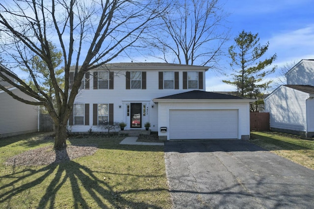 view of front facade featuring aphalt driveway, an attached garage, fence, and a front yard