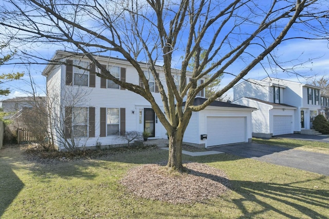 view of front of home with a front lawn, a garage, and driveway