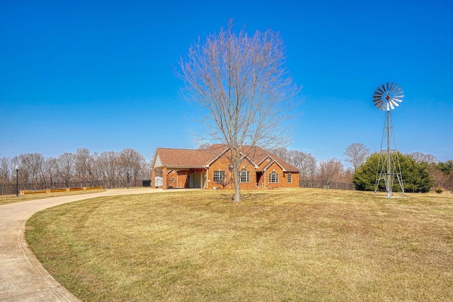 view of front facade featuring concrete driveway, a carport, and a front yard