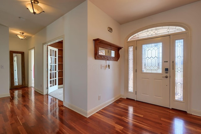 foyer with wood finished floors, baseboards, and a wealth of natural light