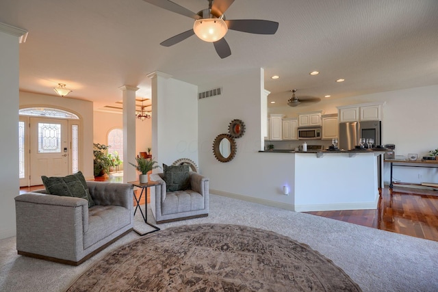 living area featuring visible vents, baseboards, ceiling fan, recessed lighting, and dark wood-style flooring