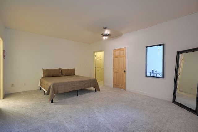 carpeted bedroom featuring baseboards