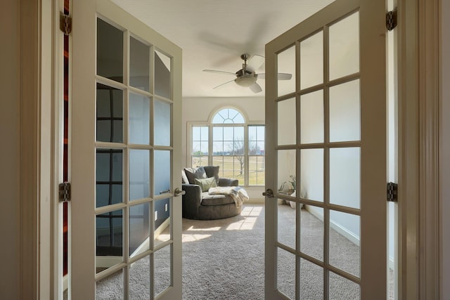 interior space with ceiling fan, french doors, and carpet