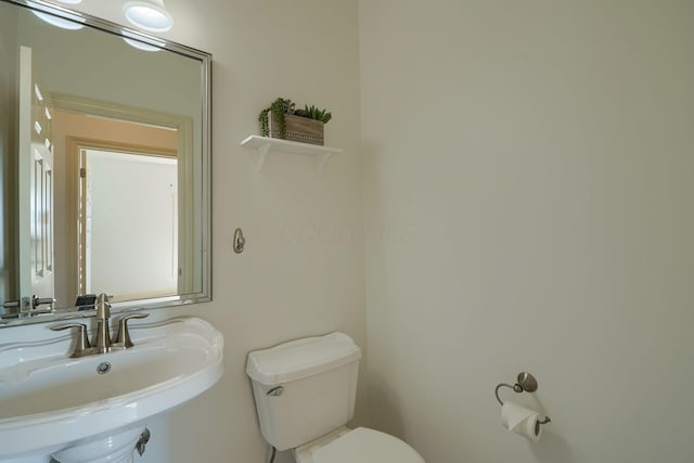 bathroom with toilet and a sink