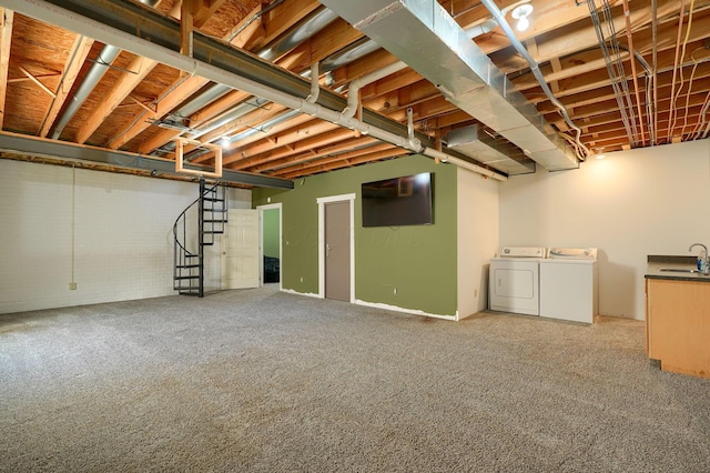 unfinished basement with washer and dryer, stairs, carpet flooring, and a sink