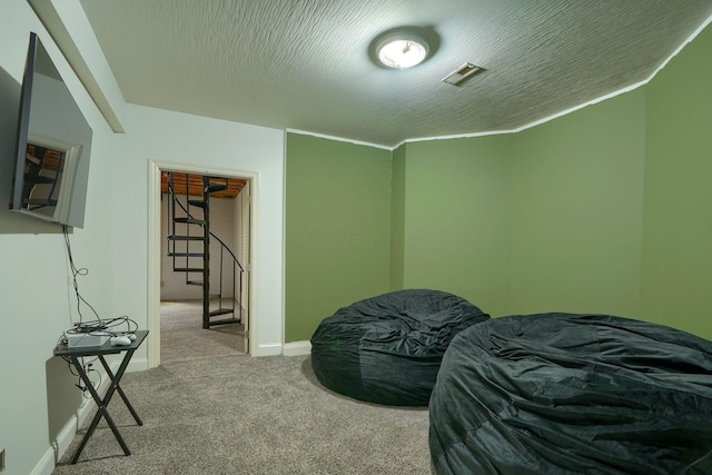 carpeted bedroom with baseboards and a textured ceiling