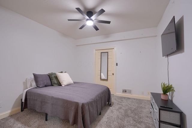 bedroom with visible vents, baseboards, light colored carpet, and a ceiling fan