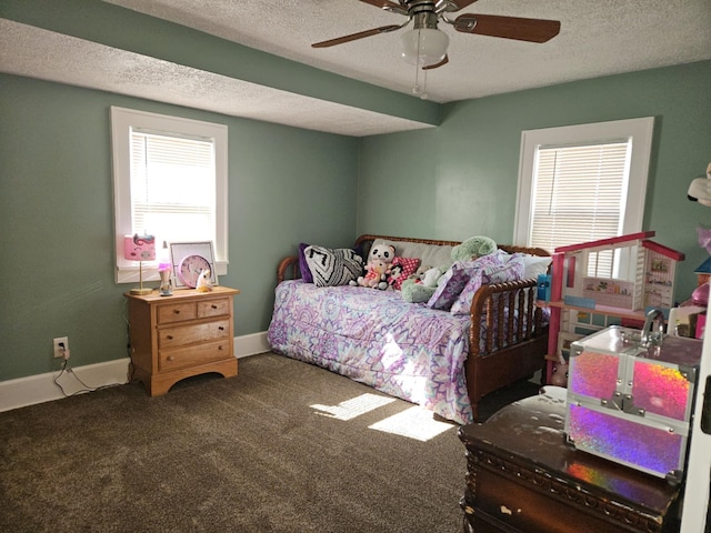 carpeted bedroom featuring ceiling fan, baseboards, and a textured ceiling