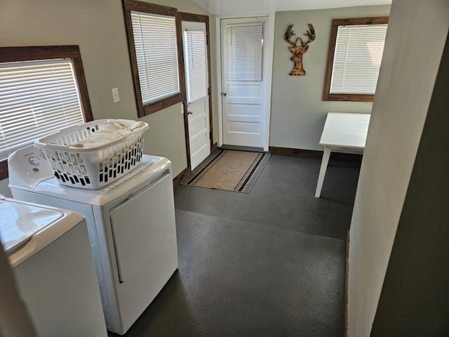 clothes washing area featuring laundry area, baseboards, and independent washer and dryer