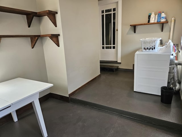 laundry room featuring washer and dryer and baseboards