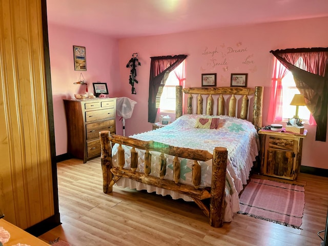 bedroom featuring light wood-style flooring and baseboards