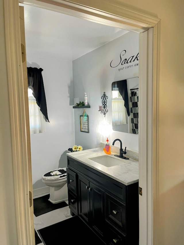 full bath featuring toilet and vanity