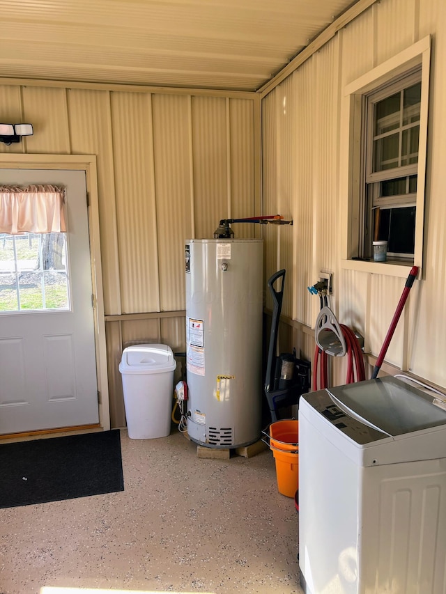 utility room featuring gas water heater and washer / dryer