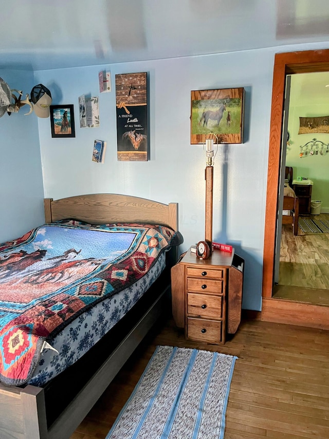 bedroom with wood finished floors