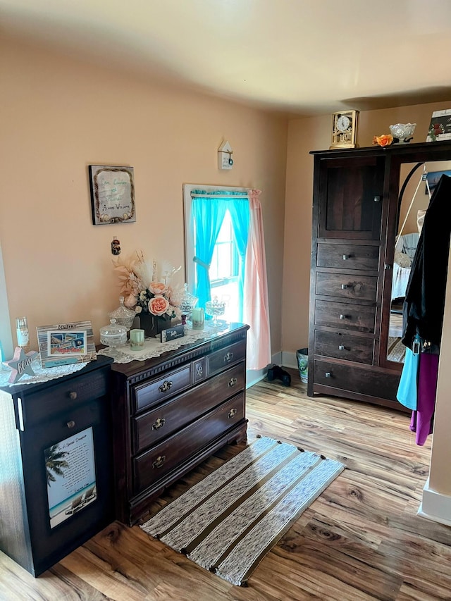 bedroom with baseboards and light wood-style floors